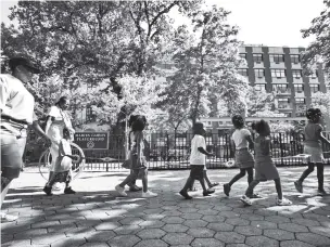  ?? BEBETO MATTHEWS/ASSOCIATED PRESS FILE PHOTO ?? Children from a day care are escorted in Marcus Garvey Park in the Harlem neighborho­od of New York in 2007. Some states have moved ahead with plans of their own to boost child care subsidies after a national effort by Democrats in Washington has been stalled.