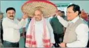  ?? PTI PHOTO ?? BJP national president Amit Shah is greeted on his way to Agartala at LGBI Airport in Guwahati on Saturday.