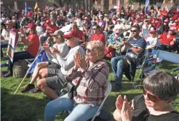  ??  ?? People applaud during a pro-Trump rally at the state Capitol as they watch a live feed of U.S. Rep. Andy Biggs, R-Ariz., speaking in Washington.