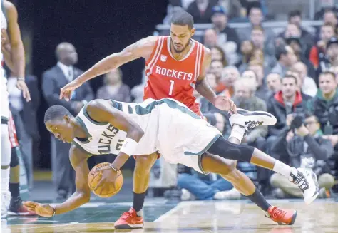  ?? — USA Today Sports ?? Milwaukee Bucks guard Tony Snell (21) tries to hold onto the ball while under pressure from Houston Rockets forward Trevor Ariza (1) in the first quarter at BMO Harris Bradley Center.