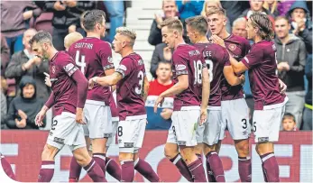  ??  ?? Hearts celebrate after Jimmy Dunne’s 65th-minute goal put the home side 2-0 up