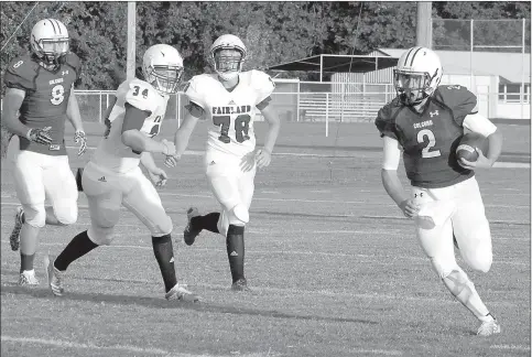  ?? Gary Comiskey/Special to Siloam Sunday ?? Colcord (Okla.) quarterbac­k Spencer Earp, right, runs around the left side for a first down during the first quarter of the Hornets’ season-opener Thursday against Fairland (Okla.).