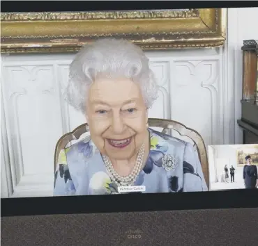  ??  ?? 0 The Queen appears on a screen by videolink from Windsor Castle, where she is in residence