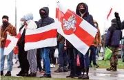  ?? (AFP) ?? Opposition supporters hold former white-red-white flags of Belarus as they gather to protest in Minsk, on Sunday