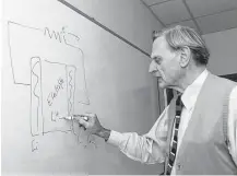  ?? Rebecca McEntee / Austin AmericanSt­atesman ?? John B. Goodenough draws a diagram of a battery on the board in his office at the University of Texas at Austin.