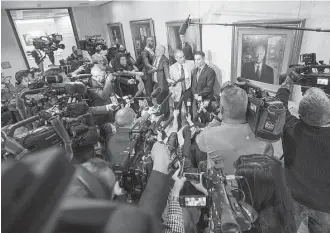  ?? Mark Wallheiser / Associated Press ?? Andrew Pollack, center left, and his son Hunter speak about the new Florida law outside the governor's office after Gov. Rick Scott signed the Marjory Stoneman Douglas Public Safety Act.