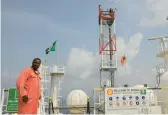  ?? SUNDAY ALAMBA/AP 2011 ?? A Shell employee stands on the deck of an oil production, storage and offloading vessel near the highly polluted Niger Delta in Nigeria.