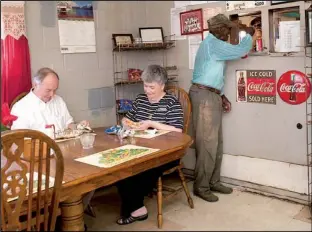  ?? Arkansas Department of Parks and Tourism/a.c. “CHUCK” HARALSON ?? Marianna Mayor Jimmy Williams (left) and his wife, Wanda, lunch at Jones’ BAR-B-Q Diner while Willie White gets a sandwich at the window.