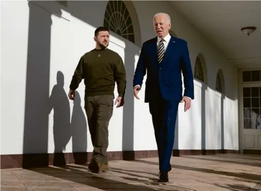  ?? BRENDAN SMIALOWSKI/AFP VIA GETTY IMAGES ?? President Biden walked with President Volodymyr Zelensky of Ukraine through the colonnade of the White House on Dec. 21.