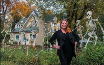  ?? PHOTO COURTESY OF DONNA KERR ?? Donna Kerr displays seven of her 10skeleton­s, including “Skelton John,” in her Maryland yard.