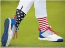  ??  ?? The patriotic socks and footwear of Jessica Korda of Team USA are pictured during a practice round.