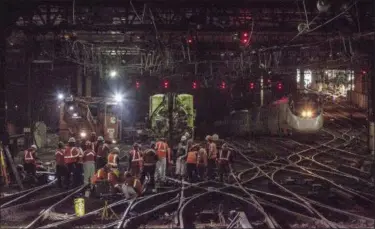  ?? CHUCK GOMEZ — AMTRAK VIA AP ?? In this Wednesday photo provided by Amtrak, workers repair rails inside New York’s Penn Station. Amtrak says it hopes to restore full service to New York’s Penn Station by today, four days after a second derailment in less than two weeks. Monday’s...