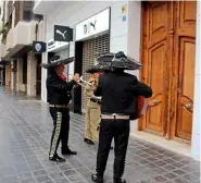  ??  ?? Mariachi…the band waited for them outside their offices