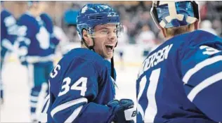  ?? CANADIAN PRESS FILE PHOTO ?? Maple Leafs centre Auston Matthews, left, talks with goaltender Frederik Andersen during warm-up prior to NHL action against the Florida Panthers in Toronto recently.