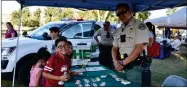  ?? RECORDER PHOTO BY JAMIE A. HUNT ?? Nathan, Jesslyn, and Adelynn Alvarez with Tulare County Sheriff Deputy Fabian Serrano at National Night Out at Zalud Park in Portervill­e, on Tuesday.