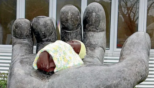  ??  ?? The baby, outside the Paraparaum­u Police Station, dressed by a yarn bomber.