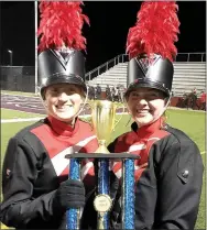  ?? Photograph submitted ?? Blackhawk band drum majors Sadie Grigg and Sydney Pejsa with the second-place trophy won by the Pea Ridge High School marching band in the 30th annual Northwest Arkansas Invitation­al Saturday, Oct. 30. The Blackhawk Marching Band finished runner-up in the eight-school field.