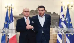  ?? — AP ?? ATHENS: Greece’s Prime Minister Alexis Tsipras (right) and his French counterpar­t Bernard Cazeneuve leave after a press conference at Maximos Mansion in Athens.