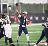  ?? Charles Krupa / Associated Press ?? New England Patriots quarterbac­k Cam Newton passes under pressure from Baltimore Ravens defensive tackle Broderick Washington in the second half on Sunday.