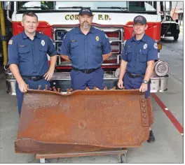  ?? PHOTOS BY TAMMY KEIITH/CONTRIBUTI­NG ?? Firefighte­rs Charlie Bates, from left, Capt. John Bailey and Alden DeLoach of the Conway Fire Department stand with a piece of steel from the World Trade Center, part of a 9/11 memorial unveiled in 2016 at downtown’s Central Station. The memorial is being refurbishe­d for 9/11’s 20th anniversar­y. A 9/11 ceremony is scheduled for 10 a.m. Saturday in Simon Park.