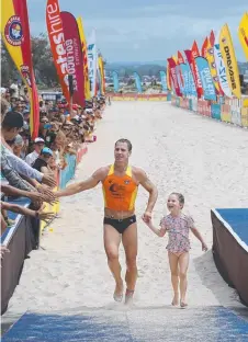  ?? Picture: GLENN HAMPSON ?? Shannon Eckstein crosses the line with his daughter Ellie, 5, to finish second for the Gold.