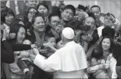  ?? ASSOCIATED PRESS ?? IN THIS APRIL 18 FILE PHOTO, Pope Francis meets a group of faithful from China at the end of his weekly general audience in St. Peter’s Square at the Vatican.