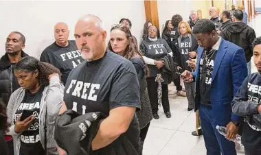  ?? Photos by Yi-Chin Lee/Staff photograph­er ?? Supporters of Antonio Armstrong Jr. wearing clothing with messages supporting him stand Monday in the hall outside the 179th District Court at the Harris County Criminal Justice Center in Houston.