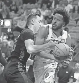  ?? RHONA WISE/USA TODAY SPORTS ?? Heat forward Duncan Robinson (55) defends Detroit Pistons guard Cade Cunningham (2) during the first half at Kaseya Center in Miami on Tuesday.