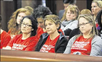  ?? BOB ANDRES / AJC ?? Women from the group Moms Demand Action watch as the bill advances. With little fanfare, the House Public Safety and Homeland Security Committee passed what has become known as the “Campus Carry” bill, which would allow students with concealed weapons...