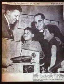  ??  ?? Roberta Hill, right, and a fellow student appeared in a newspaper with Brantford Rotary Club president Gerry McDonald, left, who was giving the kids a record player, and William Zimmerman, the Mohawk Institute’s headmaster. Zimmerman would go on to sexually abuse Roberta on multiple occasions