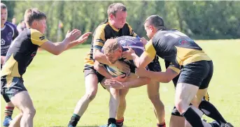  ??  ?? Menai Bridge’s Chris Roberts is stopped from crossing the try line against Nant Conwy