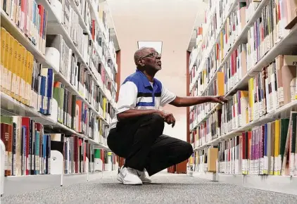  ?? Jason Fochtman/Staff photograph­er ?? Conroe resident Waymon Anderson looks through books of genealogic­al data Wednesday at the Montgomery County Central Library in Conroe. Anderson was able to trace his family line back to slaves at Greenwood Plantation in Danville.