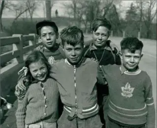  ?? LOCAL HISTORY AND ARCHIVES, HAMILTON PUBLIC LIBRARY ?? Faith Reid, left, and her brother David, standing behind her, and the Weaver boys — Fred, Jim and Bob — were the youngsters who discovered the torso of John Dick on the side of the escarpment near Albion Falls.