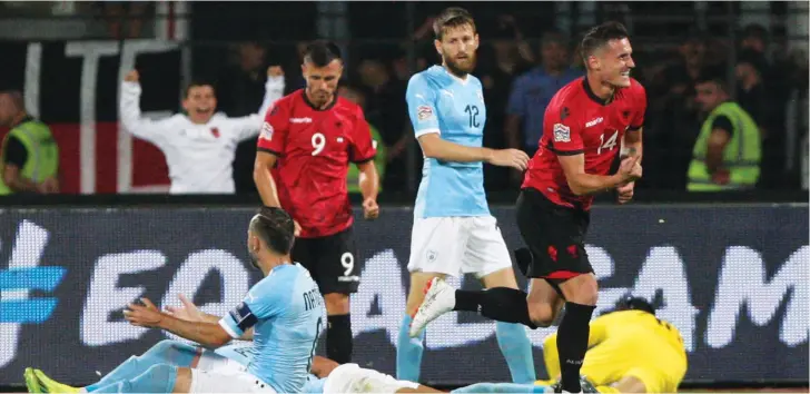  ?? (Reuters) ?? ALBANIA’S TAULANT XHAKA (right) celebrates after scoring the lone goal in his side’s 1-0 home victory over Israel on Friday night in the opening match for both countries in the group stage of the inaugural UEFA Nations League competitio­n.