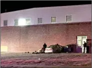  ?? (NWA Democrat-Gazette/Graham Thomas) ?? Emergency personnel work at the scene after a vehicle crashed into the Siloam Springs Intermedia­te School on Feb. 28. This is the second time in less than two months the east wall of the school gym has been hit by a vehicle.