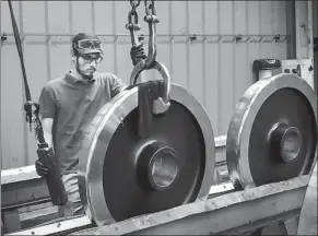  ?? PROVIDED TO CHINA DAILY ?? A worker of Valdunes, a French high-speed train wheel manufactur­er, repackages the Ma Steel highspeed train wheels to be shipped to Germany.