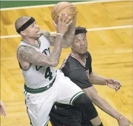 ?? CJ Gunther European Pressphoto Agency ?? CELTICS GUARD Isaiah Thomas gets around the Bulls’ Jimmy Butler for a shot during the second half. Thomas and the Celtics are a win away from advancing.