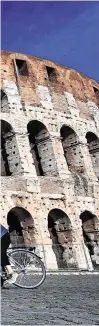  ?? PHOTO: ALBERTO PIZZOLI/AFP/GETTY IMAGES ?? Common battle: A woman rides a bike past the Colosseum in Rome yesterday, as officials announced the number of deaths from coronaviru­s in Italy now exceeds 30,000.