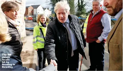  ?? Picture: PETER NICHOLLS/REUTERS ?? The PM meets locals hit by flooding in Bewdley