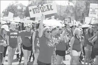  ?? CAITLIN O’HARA / THE NEW YORK TIMES ?? Educators and students last month march on the Arizona State Capitol, with calls that included increased salaries for teachers, capping classroom sizes at 25 students and raising pay for support staff. Citing a dearth of qualified local candidates,...