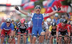  ?? – Reuters ?? POWERED TO WIN: Quick-Step Floors rider Marcel Kittel celebrates as he crosses the finishline to win the second stage of Tour de France from Duesseldor­f in Germany to Liege, Belgium on Sunday.