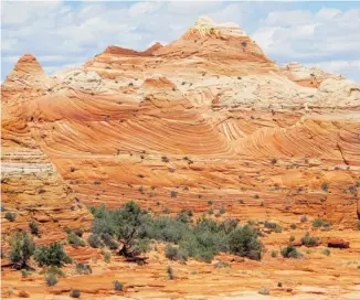  ?? BRIAN WITTE/THE ASSOCIATED PRESS ?? The swirling colourful rock formation known as The Wave is in the Vermilion Cliffs National Monument in Arizona. About one-third of visitors are from outside the U.S., particular­ly Germany, Japan and China.