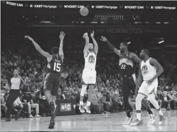  ?? Tribune News Service/getty images ?? Stephen Curry #30 of the Golden State Warriors attempts a three-point shot over Cameron Payne #15 of the Phoenix Suns during the first half of the NBA game at Footprint Center on November 30, 2021 in Phoenix.