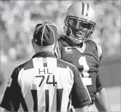  ?? David T. Foster III Charlotte Observer ?? CAROLINA QUARTERBAC­K Cam Newton questions an official after being hit by an Arizona Cardinals defender on Oct. 30.