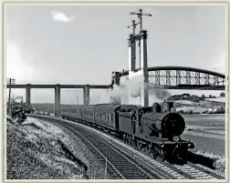  ??  ?? A WR Warship diesel-hydraulic hauls a train from Cornwall over Isambard Kingdom Brunel’s Royal Albert Bridge at Saltash, while on the Southern main line below, LSWR T9 4-4-0 No. 30717 heads the Plymouth portion of the Up ‘Atlantic Coast Express’ through the foreground on July 1, 1960.