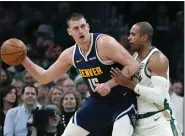  ?? MICHAEL DWYER — THE ASSOCIATED PRESS ?? Nuggets center Nikola Jokic is defended by the Celtics’ Al Horford during the first half of Friday’s game in Boston.