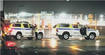  ??  ?? Police cars at Gatwick Airport following the drone sightings