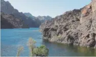  ??  ?? Hikers make their way along the banks of the Colorado River near Willow Beach, Ariz.