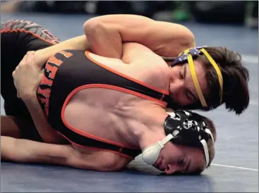  ??  ?? Ridgeland’s Jacob Mariakis locks up LaFayette’s Zach Price during a 138-pound bout during the Area 6-AAAA Duals at Heritage last Tuesday. The Panthers knocked off both Heritage and Northwest Whitfield to earn their first trip to the GHSA State Duals in...