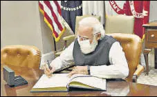  ?? PTI ?? Indian PM Narendra Modi signs the visitors’ book in the Roosevelt Room at the White House in Washington, DC.